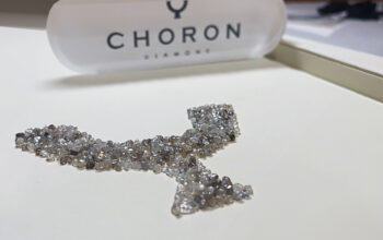 Loose Rough Diamonds Lined Up to Form Choron Group’s Brand Logo