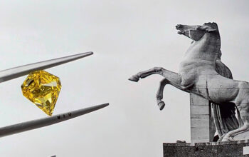 Close Up of Yellow Diamond with a Horse Monument in the Background